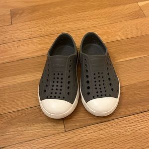 Dark Gray Native Shoes with yellow lightning around heel